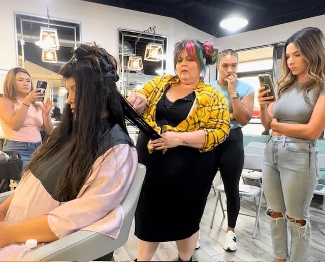 Karli teaching and demonstrating hair techniques